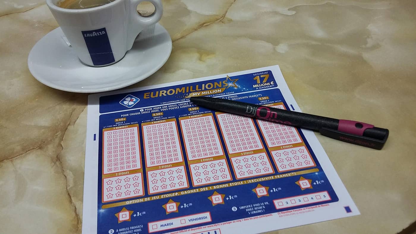 Grille EuroMillions avec une tasse de café et un stylo